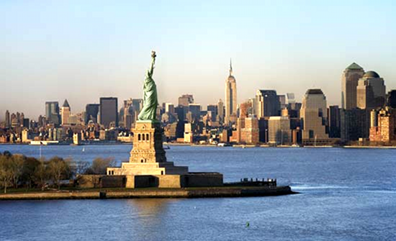 Statue of Liberty, New York City skyline at day